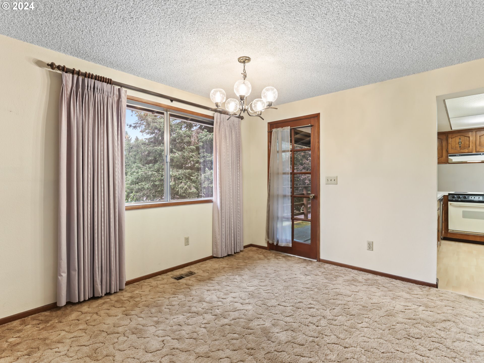 2002 Northwest 127th Street Vancouver, WA 98685 - Photo 7 of 33 a view of an empty room with window and chandelier kitchen