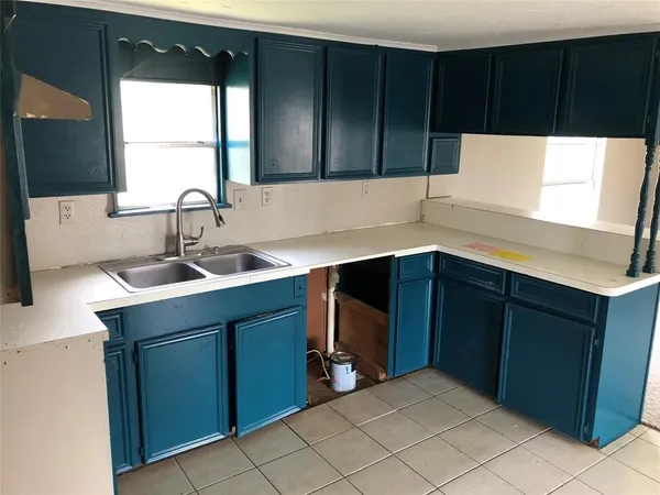 a kitchen with a sink and cabinets