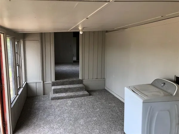 a view of storage and utility room with a fireplace