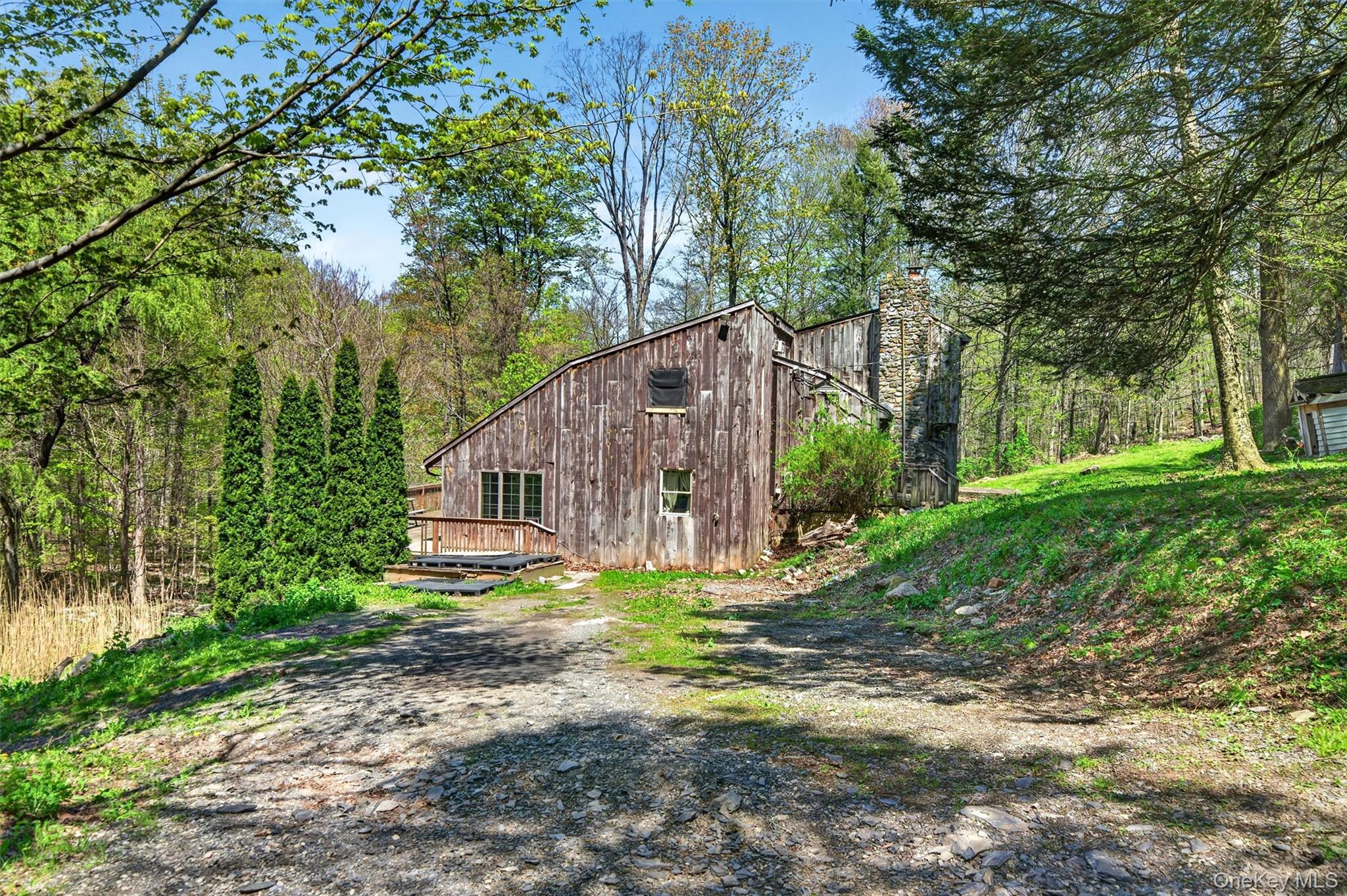 360 Buttermilk Falls Road Warwick, NY 10990 - Photo 2 of 30 a backyard of a house with plants and large trees