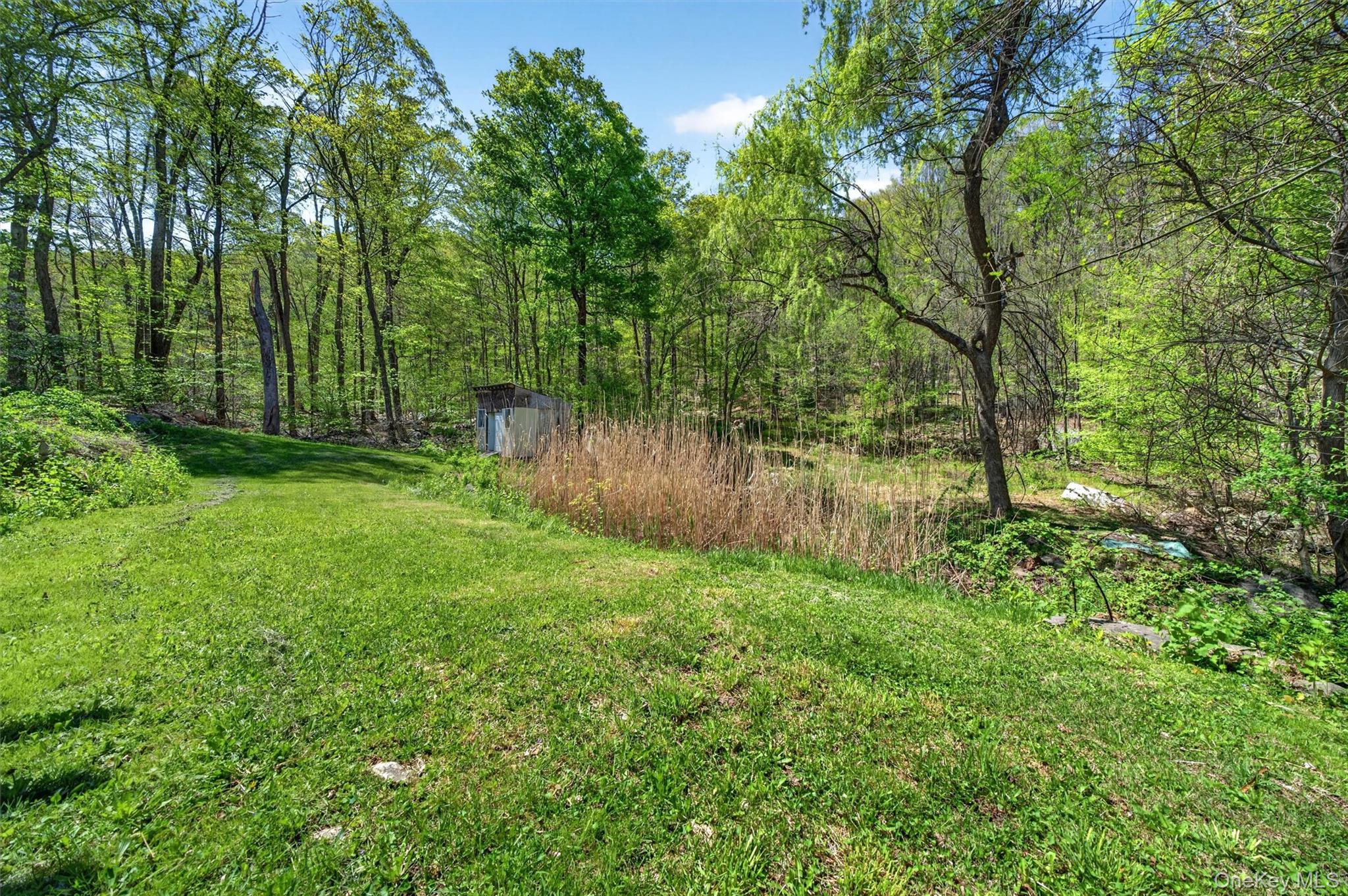 360 Buttermilk Falls Road Warwick, NY 10990 - Photo 26 of 30 a backyard of a house with lots of green space