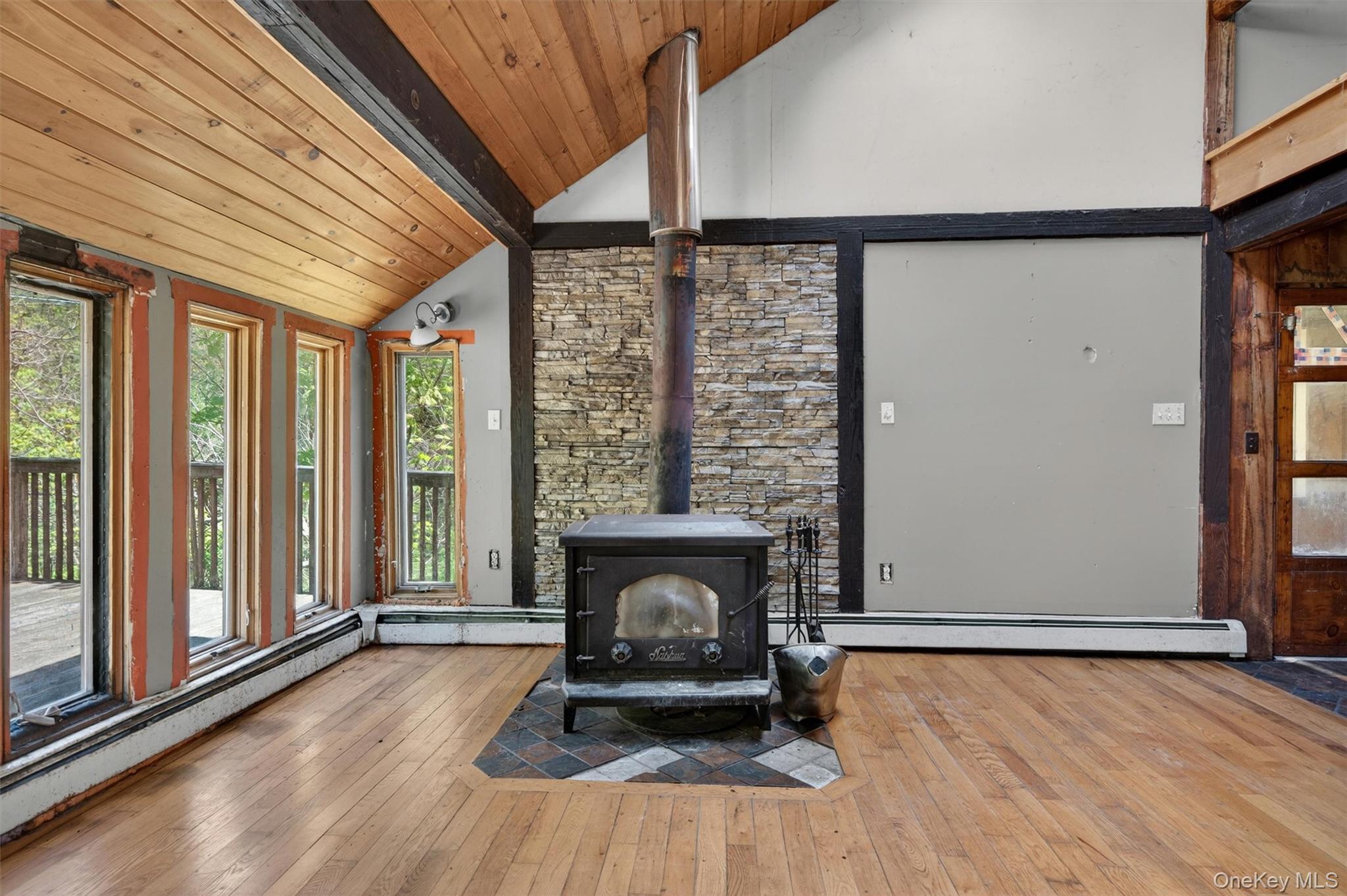 360 Buttermilk Falls Road Warwick, NY 10990 - Photo 10 of 30 a living room with a fireplace furniture and a large window