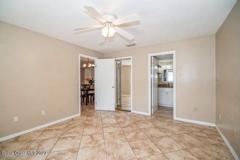 2418 Delys Street Cocoa, FL 32926 - Photo 8 of 12 an empty room with closet and ceiling fan