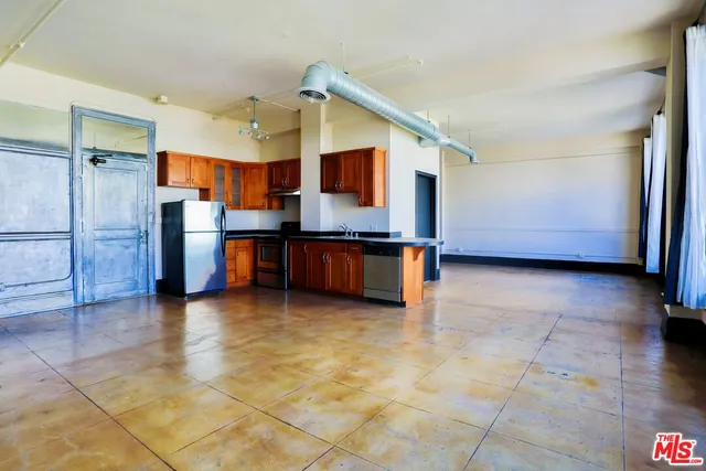 a view of kitchen with stainless steel appliances granite countertop a refrigerator and a stove