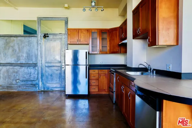 a kitchen with wooden floors and cabinet