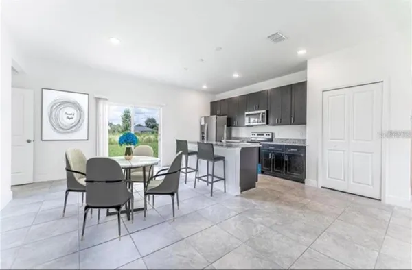 a dining room with furniture a window and kitchen view