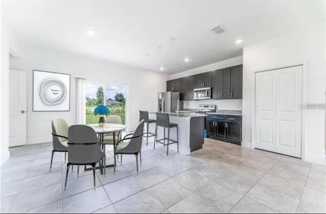 a dining room with furniture a window and kitchen view