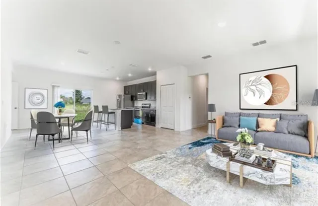 a living room with furniture and a painting on the wall