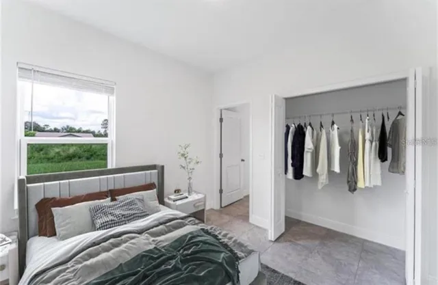 a bedroom with a bed and a window