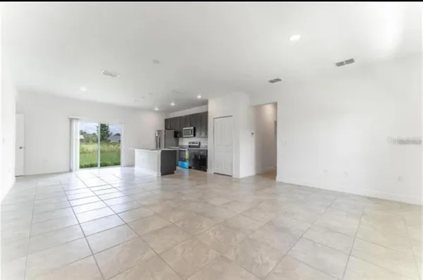 a view of livingroom with furniture and kitchen view