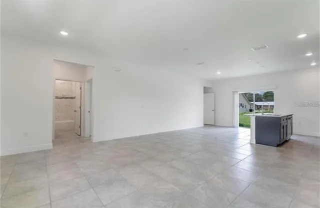 a view of a kitchen with furniture and wooden floor