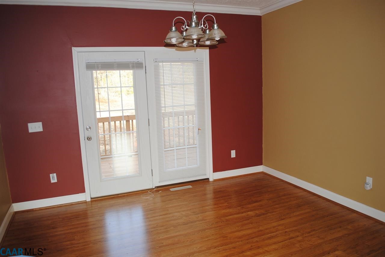 Formal dining room located next to kitchen and formal living room with rear doors leading to spacious deck.