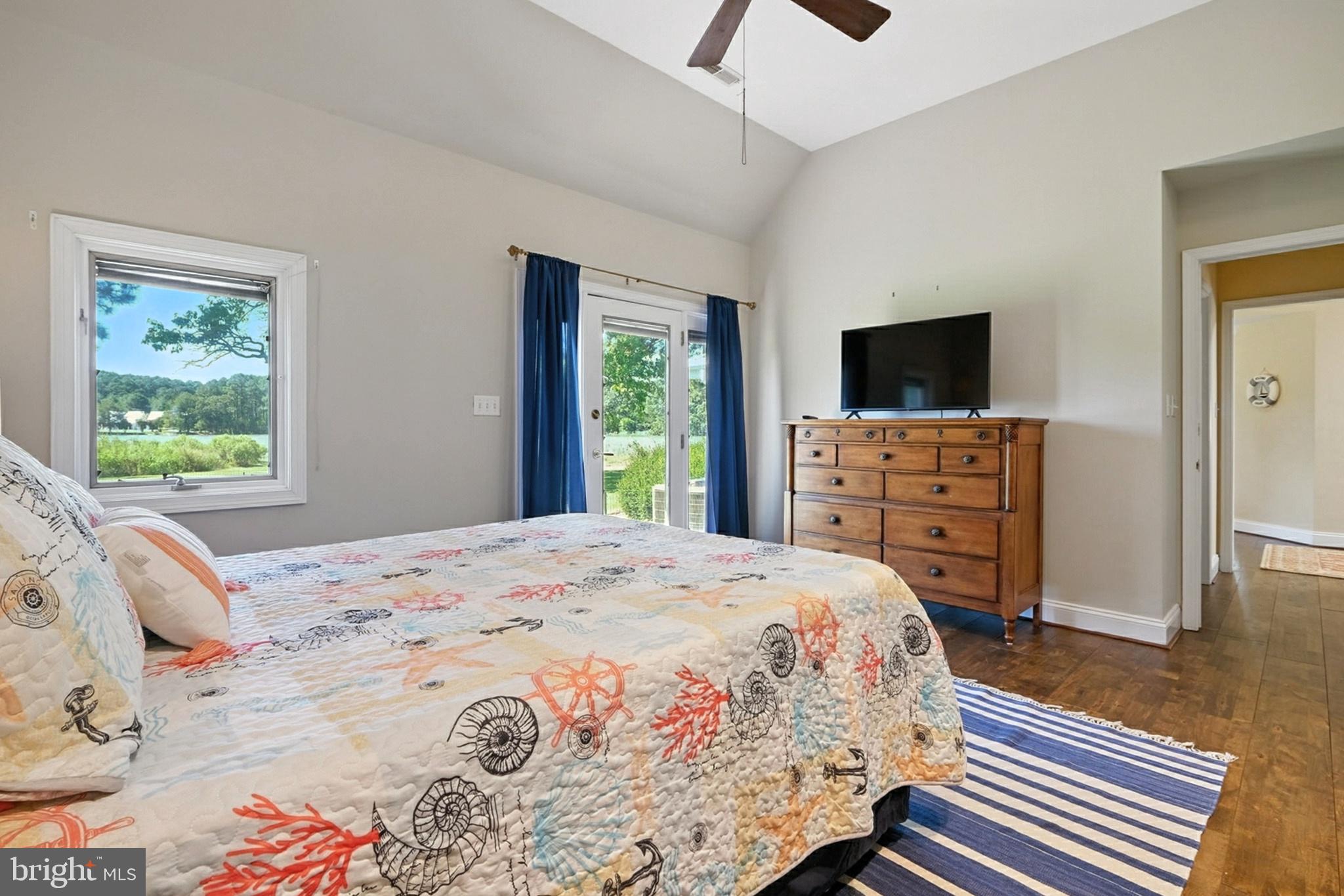 7312 Solitude Road St. Michaels, MD 21663 - Photo 34 of 43 a bedroom with a bed and a flat screen tv