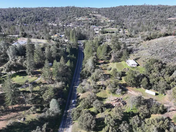 an aerial view of house with yard and mountain view