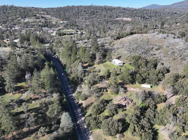 an aerial view of house with yard and mountain view