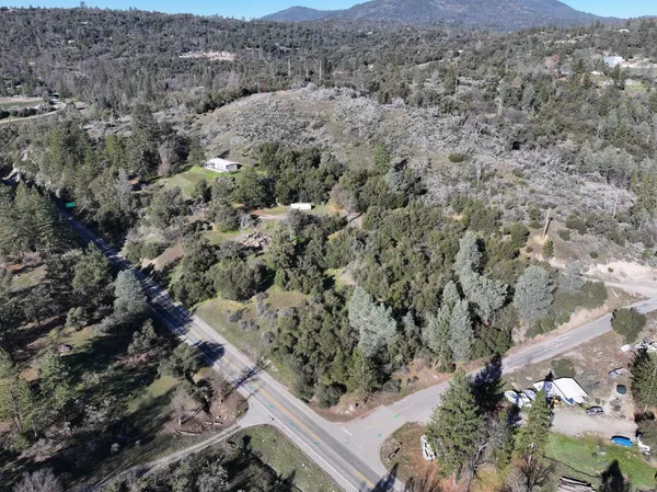 an aerial view of a house with a mountain