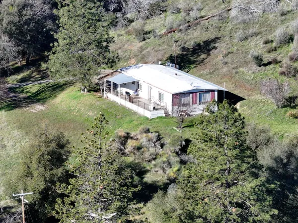 an aerial view of a house with a yard