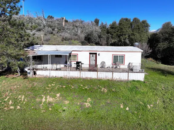 a view of a lush green hillside and a houses