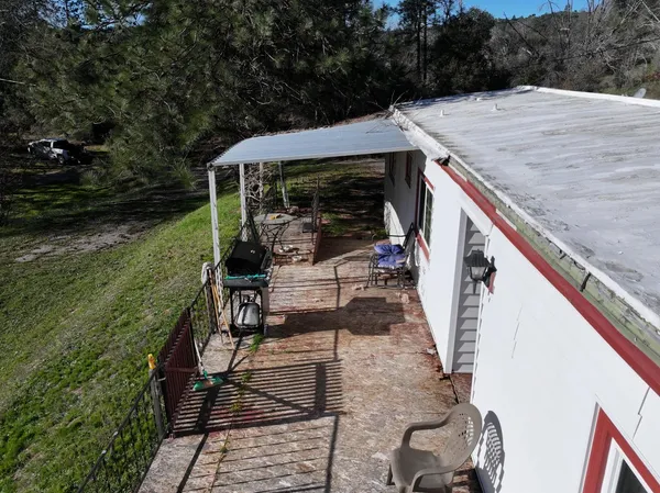 a front view of building with outdoor seating and trees