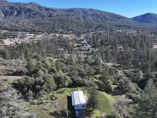an aerial view of residential house and sandy dunes