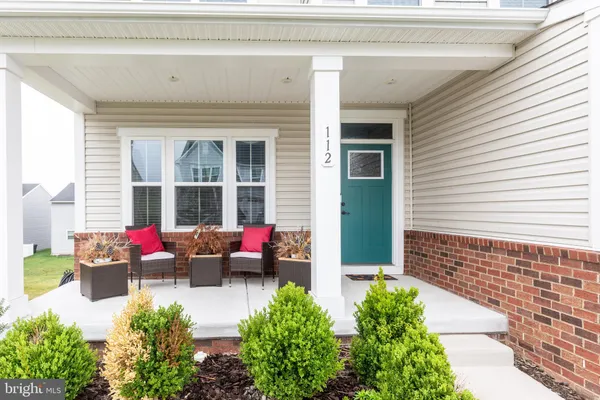 a front view of a house with outdoor seating