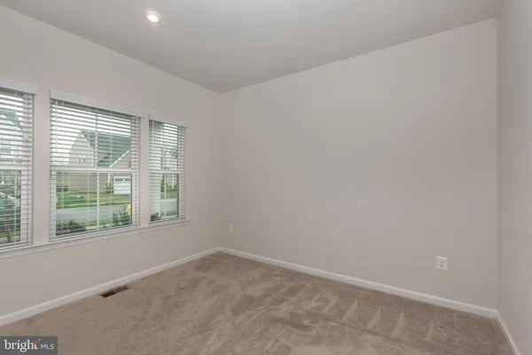 a view of a livingroom with a flat screen tv and a large window