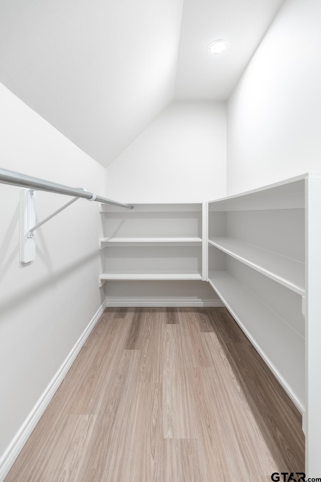 233 Harrison Street Longview, TX 75601 - Photo 29 of 44 a view of walk in closet with empty racks