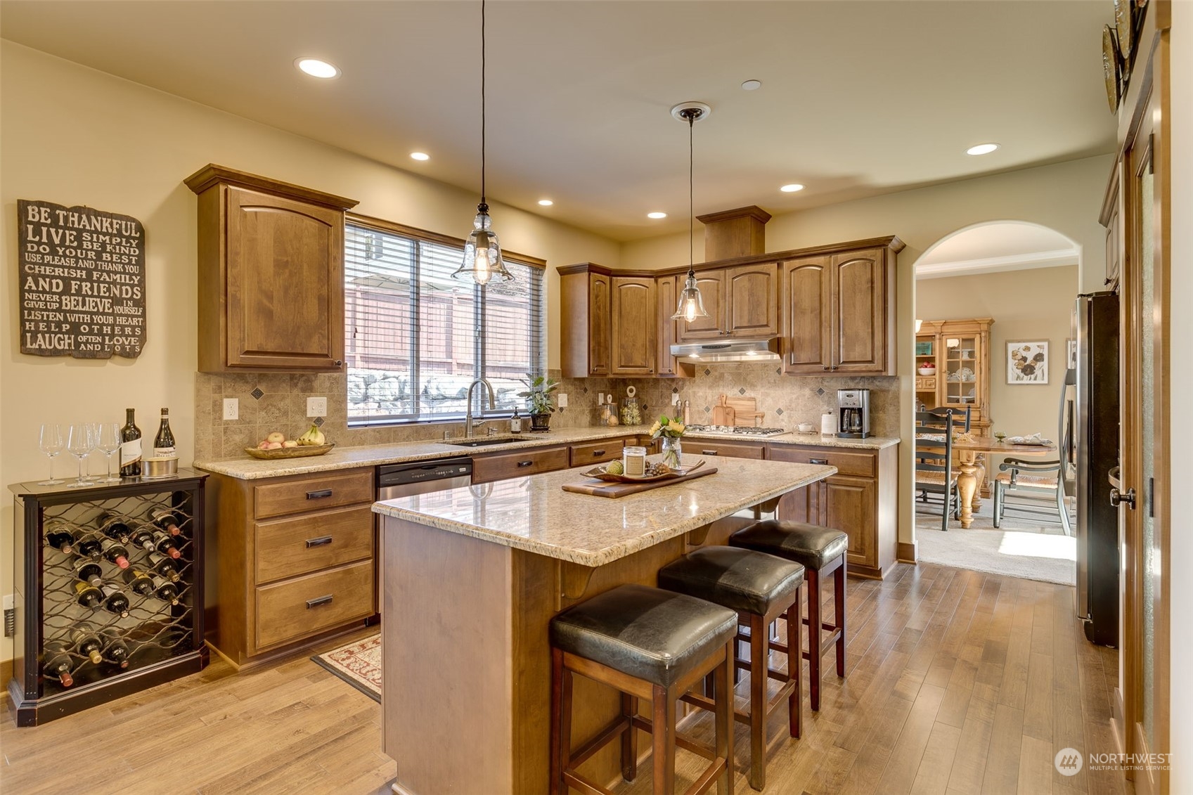 3119 223rd Street Southeast Bothell, WA 98021 - Photo 12 of 40 a kitchen with a refrigerator a sink dishwasher a dining table and chairs