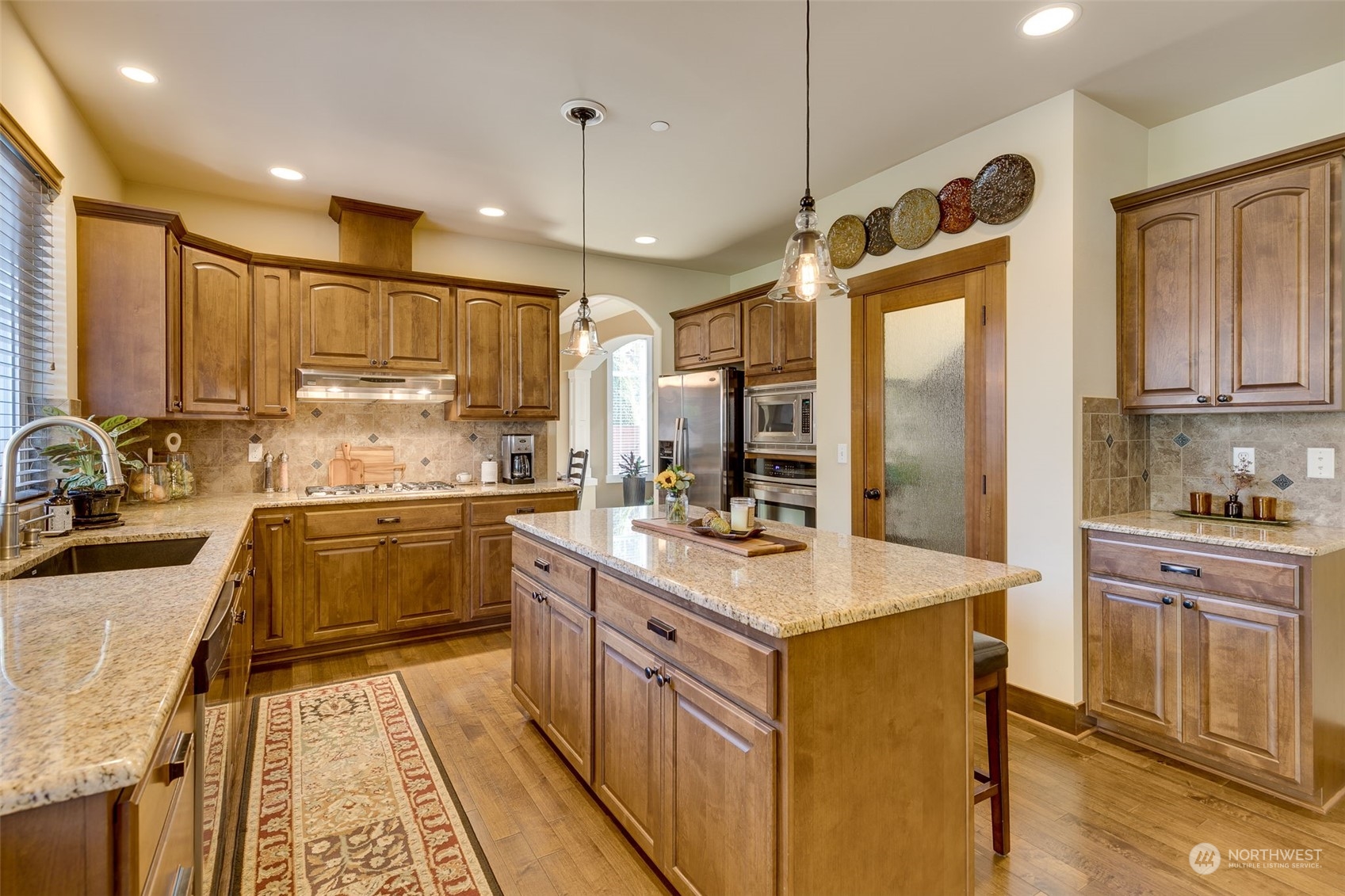 3119 223rd Street Southeast Bothell, WA 98021 - Photo 13 of 40 a kitchen with stainless steel appliances granite countertop a sink stove and refrigerator