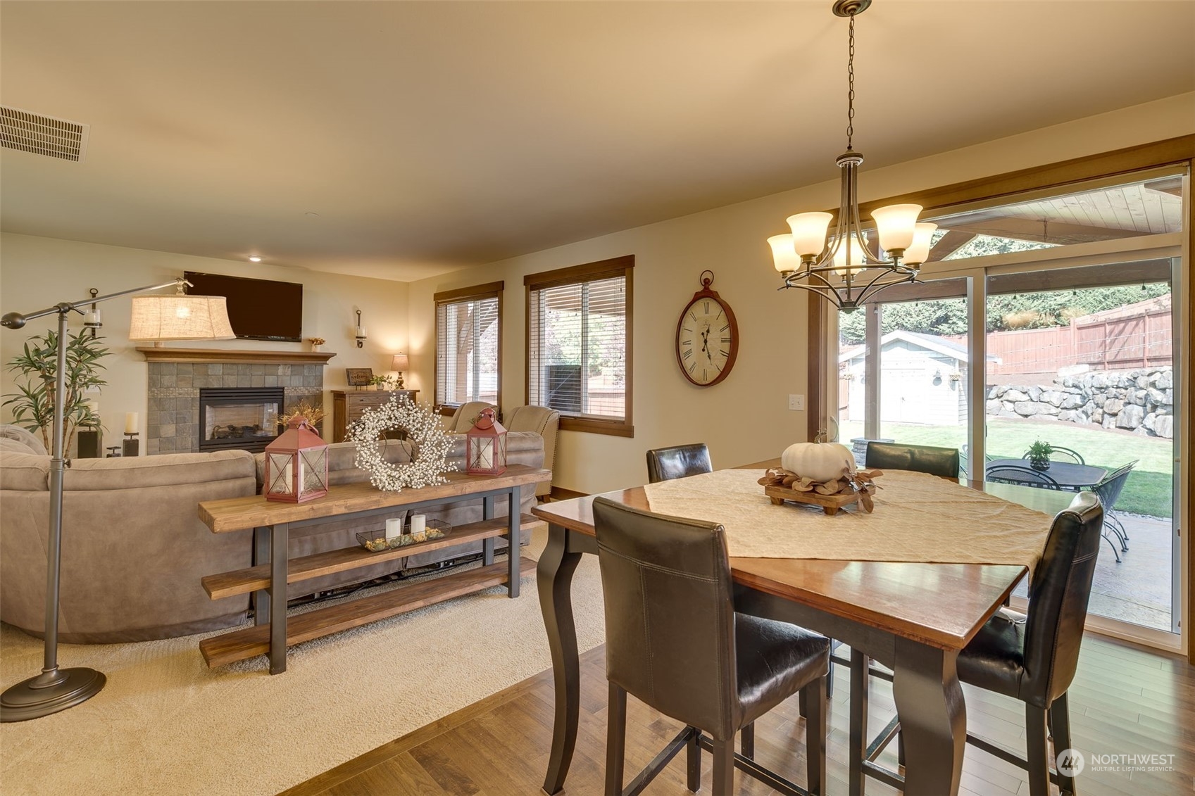 3119 223rd Street Southeast Bothell, WA 98021 - Photo 15 of 40 a view of a dining room with furniture a chandelier and large windows