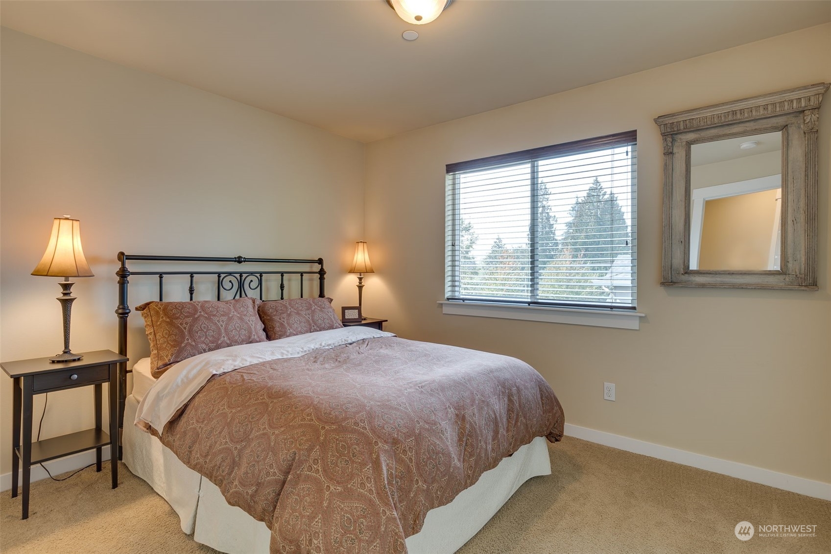 3119 223rd Street Southeast Bothell, WA 98021 - Photo 24 of 40 a large bed sitting in a bedroom next to a window