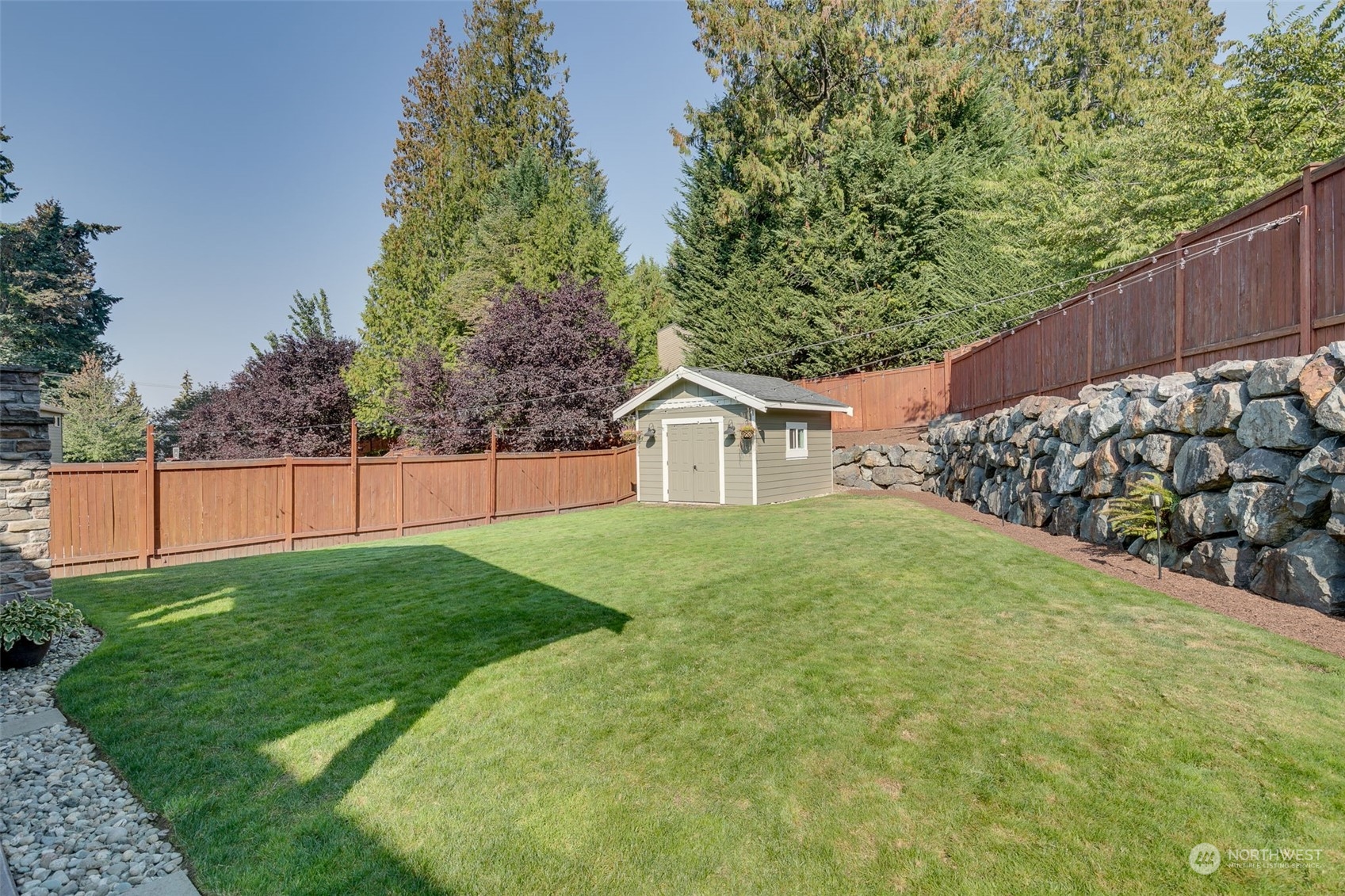 3119 223rd Street Southeast Bothell, WA 98021 - Photo 31 of 40 a view of a backyard with wooden fence
