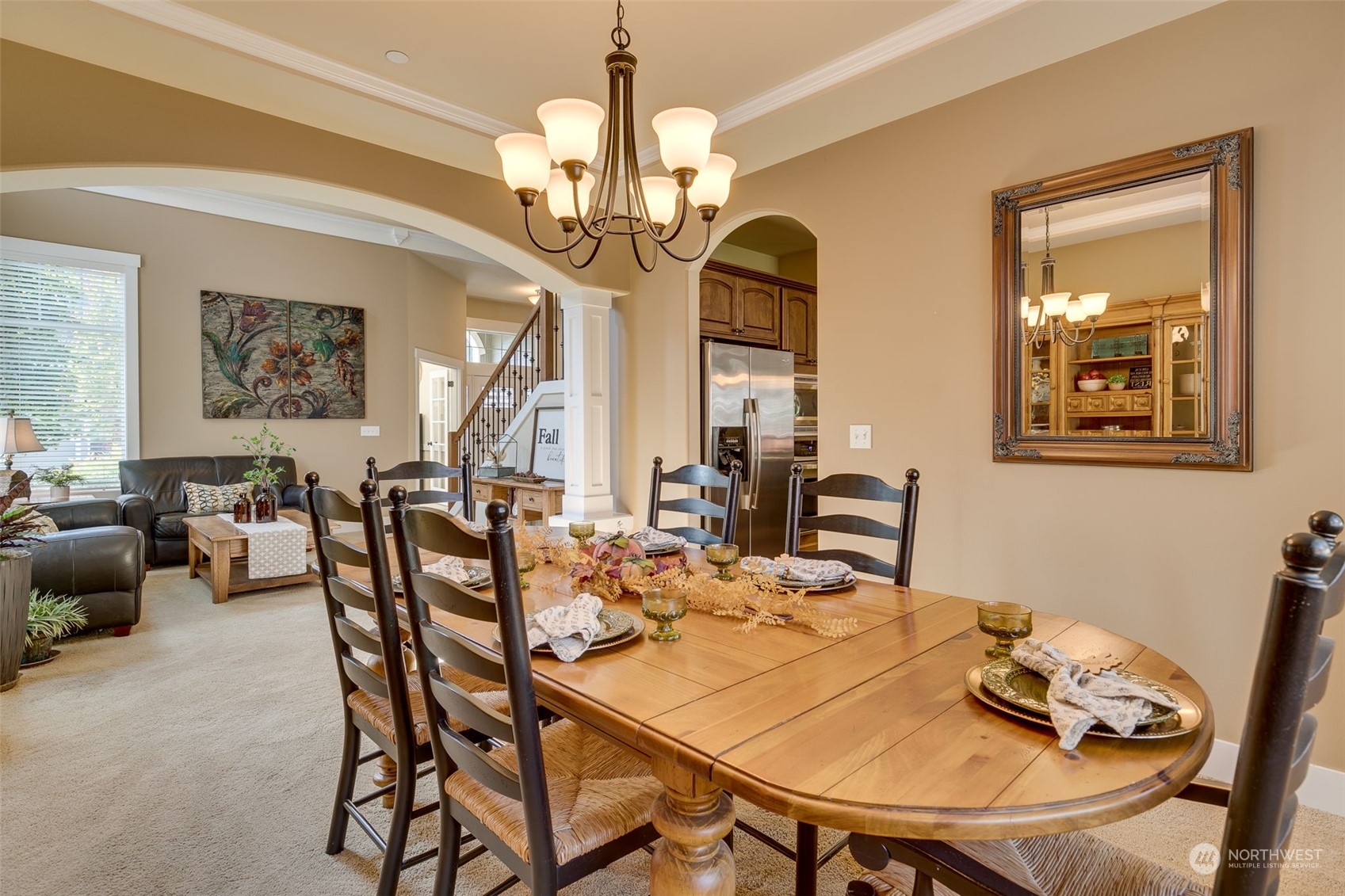 3119 223rd Street Southeast Bothell, WA 98021 - Photo 10 of 40 a view of a dining room with furniture a chandelier and wooden floor