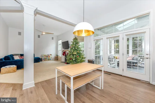 a kitchen with kitchen island white cabinets and stainless steel appliances