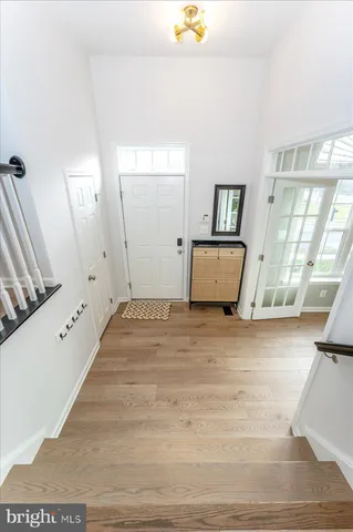 a view of a living room and hallway with wooden floor