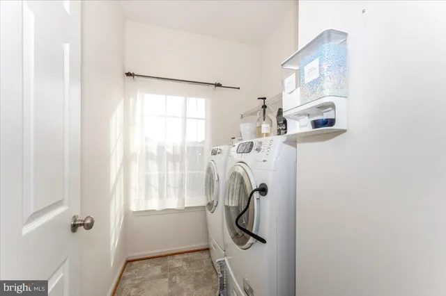 a view of staircase with white walls and a window
