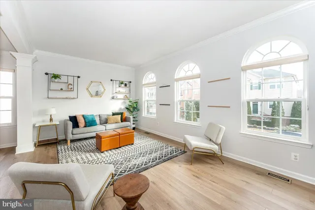 a living room with furniture a rug and a table