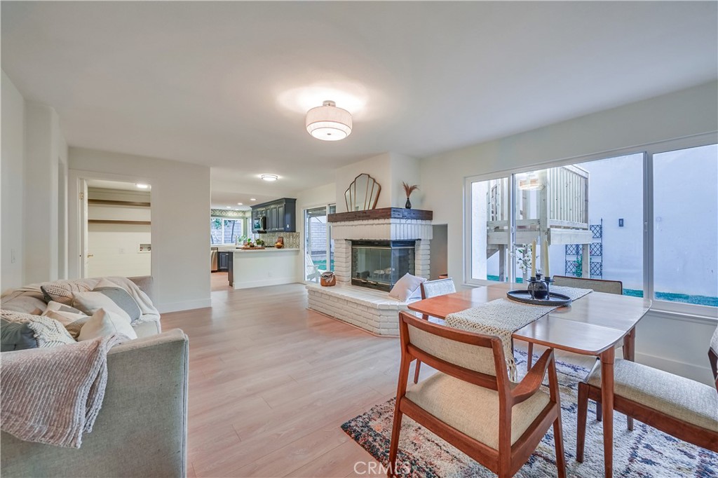 1626 Turquoise Drive Corona, CA 92882 - Photo 15 of 60 a dining room with furniture and a fireplace