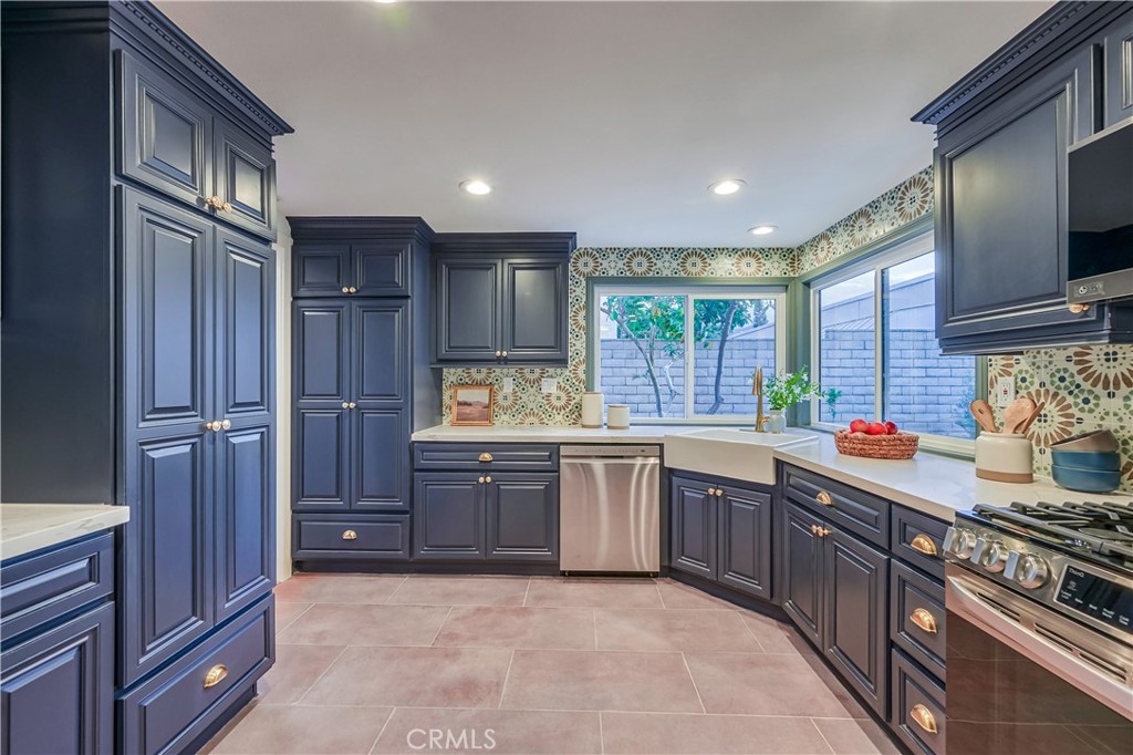 1626 Turquoise Drive Corona, CA 92882 - Photo 19 of 60 a kitchen with stainless steel appliances granite countertop a sink stove and refrigerator