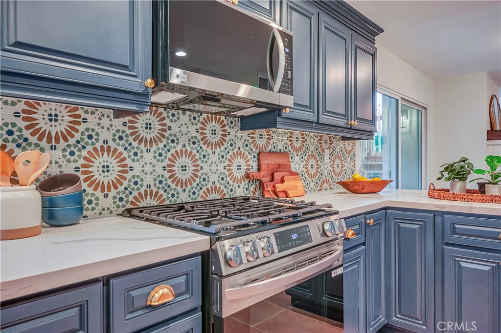 1626 Turquoise Drive Corona, CA 92882 - Photo 21 of 60 a kitchen with a stove and cabinets