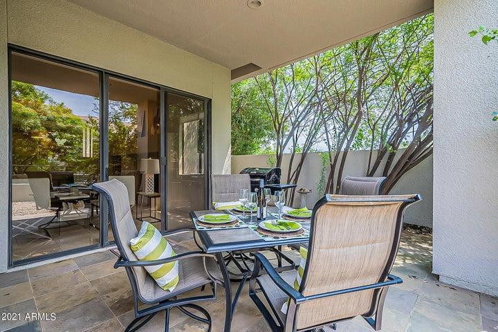7700 East Gainey Ranch Road, Unit 153 Scottsdale, AZ 85258 - Photo 22 of 24 a dining room with furniture and garden view