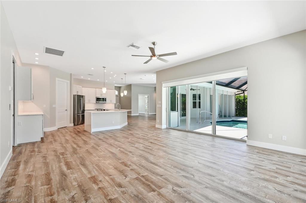 4231 Crayton Road Naples, FL 34103 - Photo 21 of 46 a view of a kitchen with furniture and wooden floor