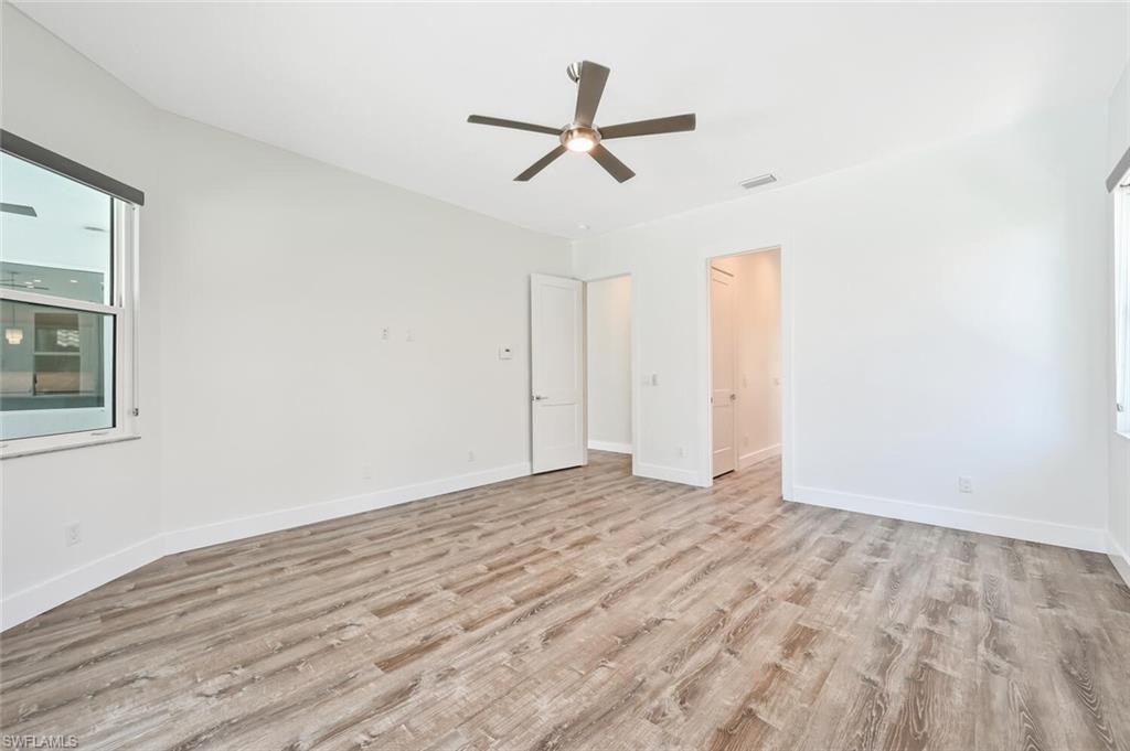 4231 Crayton Road Naples, FL 34103 - Photo 24 of 46 a view of empty room with wooden floor and ceiling fan