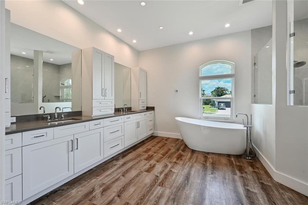 4231 Crayton Road Naples, FL 34103 - Photo 25 of 46 a large bathroom with a large tub and sink