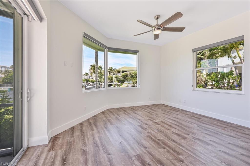 4231 Crayton Road Naples, FL 34103 - Photo 28 of 46 wooden floor in an empty room with a window