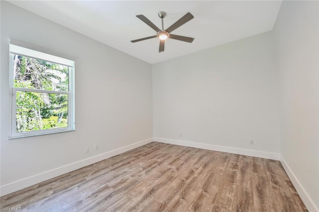 4231 Crayton Road Naples, FL 34103 - Photo 33 of 46 an empty room with a window and a ceiling fan