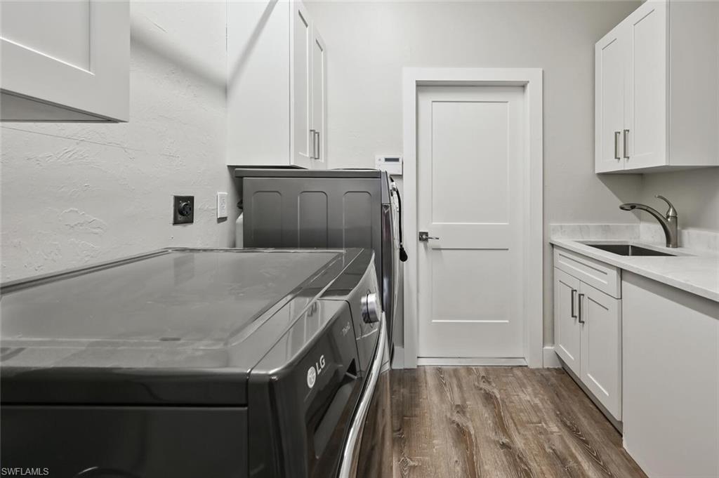 4231 Crayton Road Naples, FL 34103 - Photo 34 of 46 a kitchen with a sink and a refrigerator