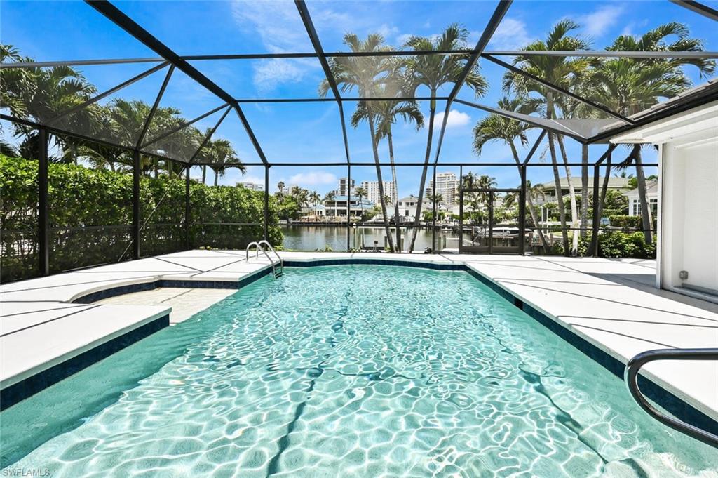 4231 Crayton Road Naples, FL 34103 - Photo 35 of 46 a view of a swimming pool with a patio