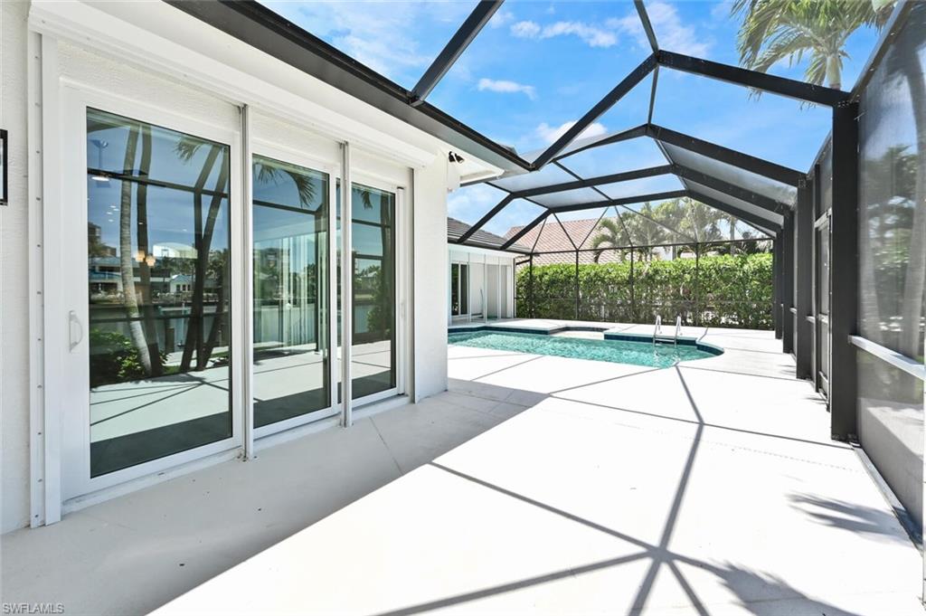4231 Crayton Road Naples, FL 34103 - Photo 40 of 46 a view of a porch with a garden