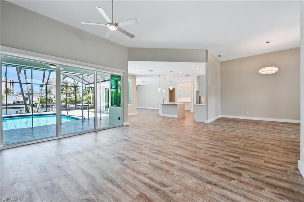 4231 Crayton Road Naples, FL 34103 - Photo 4 of 46 a view of empty room with wooden floor and fan